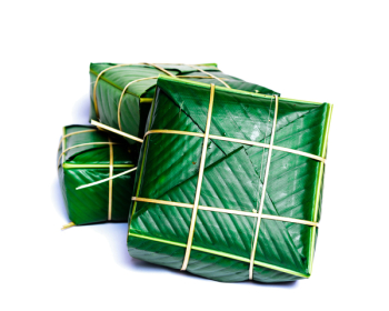 Uncooked Vietnamese Chung Cake isolated on white. It??s a square glutinous sticky rice cake, stuffed with pork meat, green beans and wrapped in bamboo leaf.  Traditional Vietnamese New Year (Tet) food.