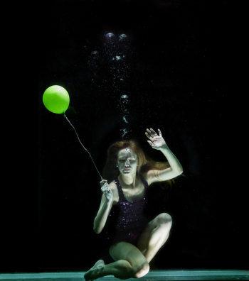 Underwater Photography of Woman Holding Green Balloon Underwater Photography of Woman Holding Green Balloon