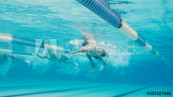 Underwater view athletic male swimmers competing in swimming pool