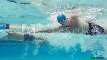 Underwater view athletic male swimmers competing in swimming pool