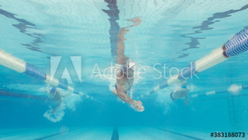Underwater view athletic male swimmers competing in swimming pool
