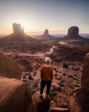 Unknown Person Standing on Brown Rock Formation Unknown Person Standing on Brown Rock Formation