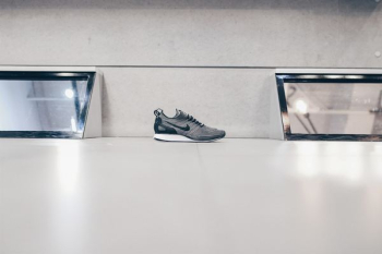 unpaired black and gray Nike running shoe on floor unpaired black and gray Nike running shoe on floor