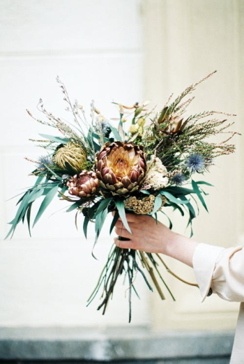 Unrecognizable Female Hand Holding Bunch of Exotic Extraordinary Flowers · Free Stock Photo