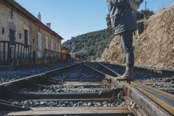 Unrecognizable tourist standing on railway Unrecognizable tourist standing on railway