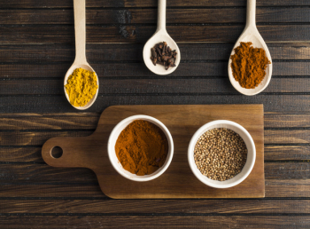 Various spices near cutting board Various spices near cutting board