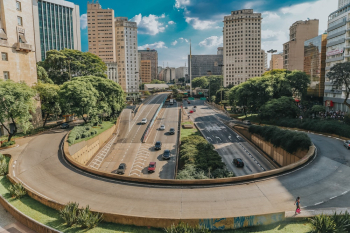 Vehicles Traveling on Road Near Buildings Vehicles Traveling on Road Near Buildings