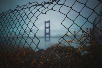 view a fence hole of San Francisco bridge view a fence hole of San Francisco bridge