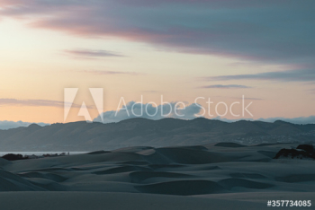 View of sand dunes against cloudy sky View of sand dunes against cloudy sky