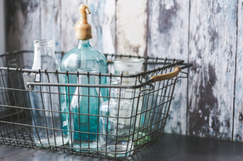 Vintage empty bottles in metal basket Vintage empty bottles in metal basket