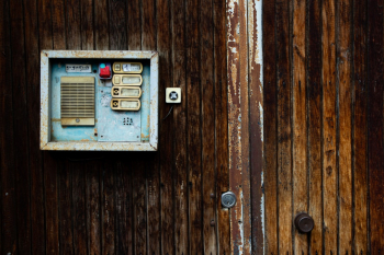 Vintage intercom on the wooden door
