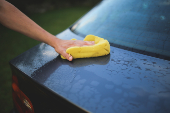 Washing a car with a sponge Washing a car with a sponge