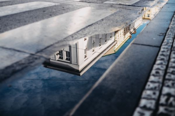 water reflection of concrete building