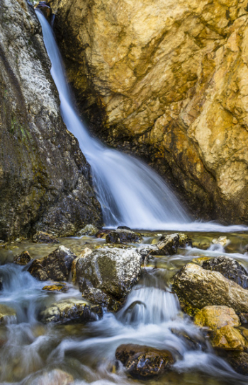 Water Stream Between Brown Rocks Water Stream Between Brown Rocks