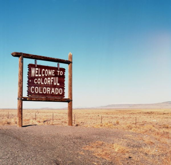 Welcome signage on road during daytime Welcome signage on road during daytime