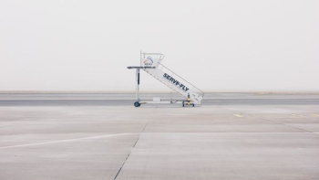 white airliner stairs on runway white airliner stairs on runway