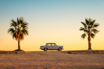 white and black car on brown sand during daytime white and black car on brown sand during daytime