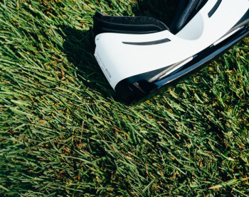 white and black VR Box headset on green grass field white and black VR Box headset on green grass field