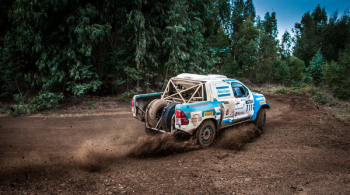 White And Blue Pickup Truck Drifting On Curve Dirt Road