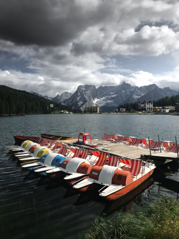 White and Multicolored Watercraft On Body of Water White and Multicolored Watercraft On Body of Water