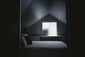 white bed frame beside attic window white bed frame beside attic window