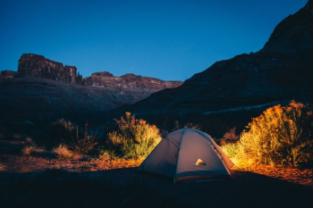 white camping tent beside mountain white camping tent beside mountain