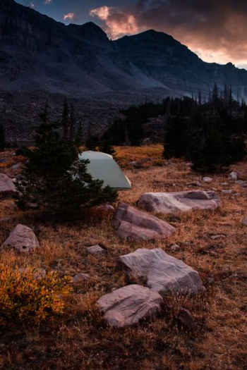 white camping tent near mountain during daytime white camping tent near mountain during daytime