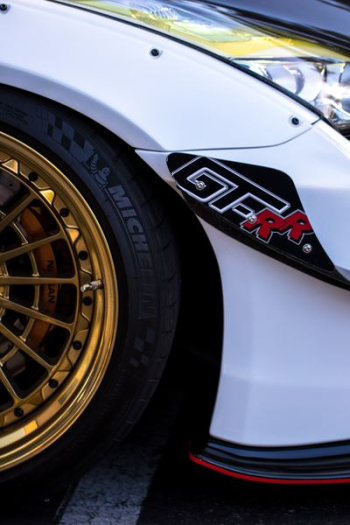 white car with gold-colored wheels and tires white car with gold-colored wheels and tires