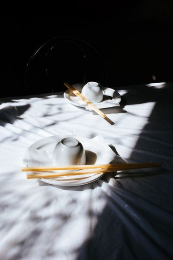 white ceramic teacup and saucer on white tablecloth white ceramic teacup and saucer on white tablecloth
