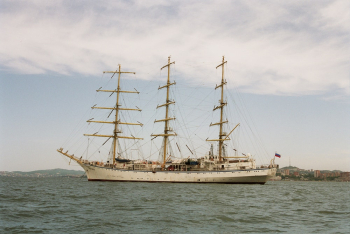 White Clipper Ship on Ocean Under Cloudy Sky
