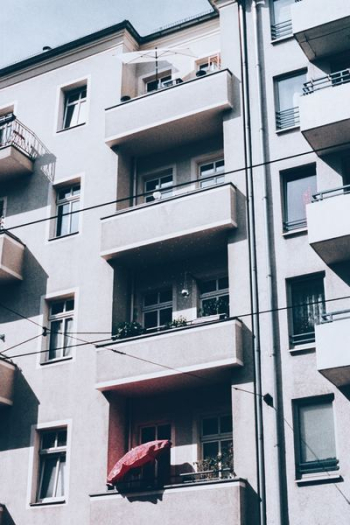 white concrete apartment building white concrete apartment building