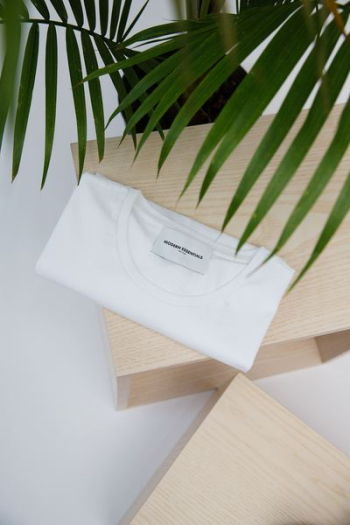 white crew-neck top on tabletop white crew-neck top on tabletop