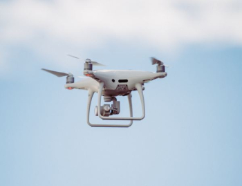 white DJI drone in mid air white DJI drone in mid air