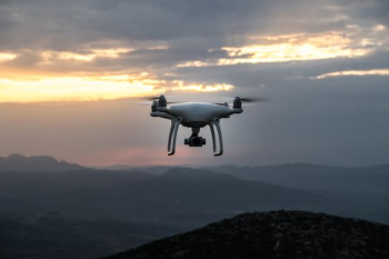 white DJI quadcopter drone flying in mid-air white DJI quadcopter drone flying in mid-air