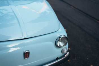 white FIAT car parked on asphalt road