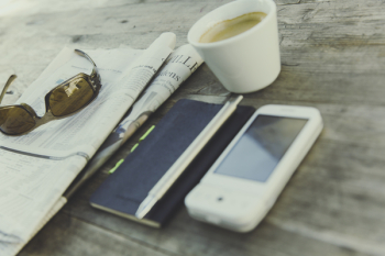 White Phone Near Black Note With Coffee