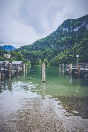 white post on body of water white post on body of water