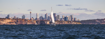 White Sailboat on Body of Water Near City White Sailboat on Body of Water Near City