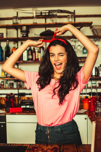 Winking Woman Holding Her Hairband Winking Woman Holding Her Hairband