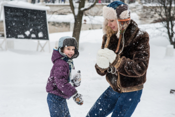 Woman and Child Playing in Snow Woman and Child Playing in Snow
