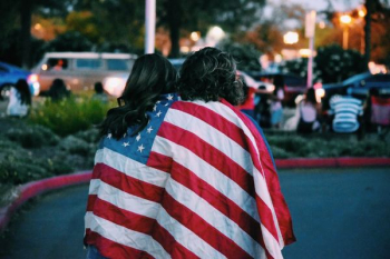 woman and man covered USA flag woman and man covered USA flag