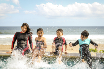 Woman and Three Children Playing Water Woman and Three Children Playing Water