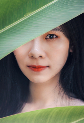 Woman Behind Banana Leaves Woman Behind Banana Leaves