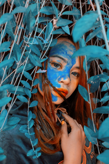 Woman Behind Blue Leaves Woman Behind Blue Leaves
