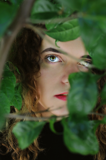 Woman Behind Green Plant Woman Behind Green Plant