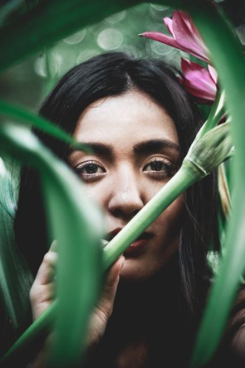woman behind plants woman behind plants