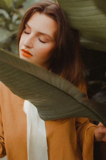woman beside green leaf woman beside green leaf