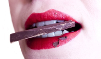 Woman Biting Brown Chocolate Woman Biting Brown Chocolate