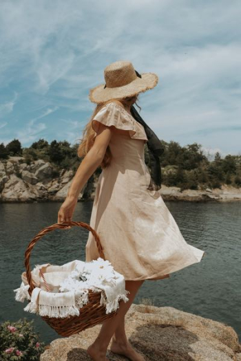 woman carrying brown wicker basket woman carrying brown wicker basket