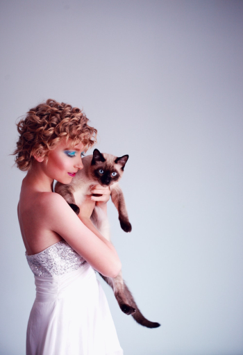 Woman Carrying Siamese Cat Woman Carrying Siamese Cat